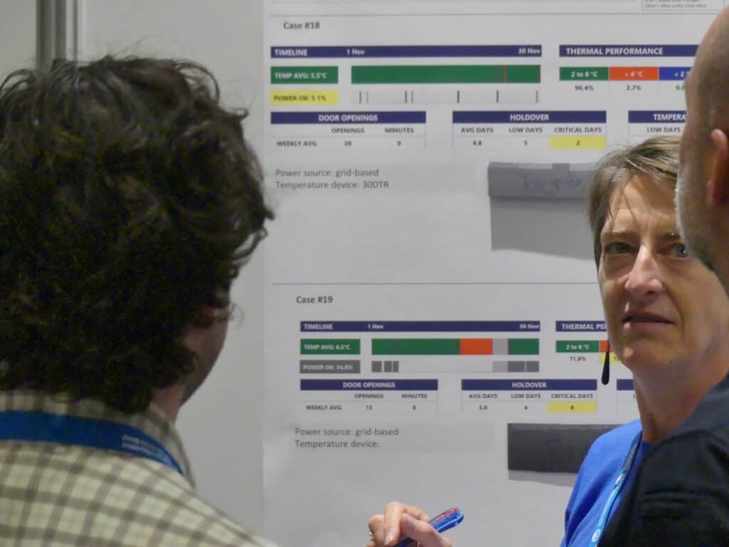 Participants look at a poster at a conference.