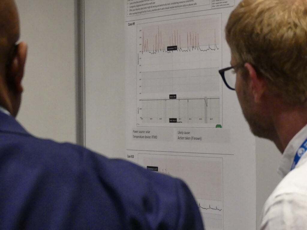 Participants look at a poster at a conference.