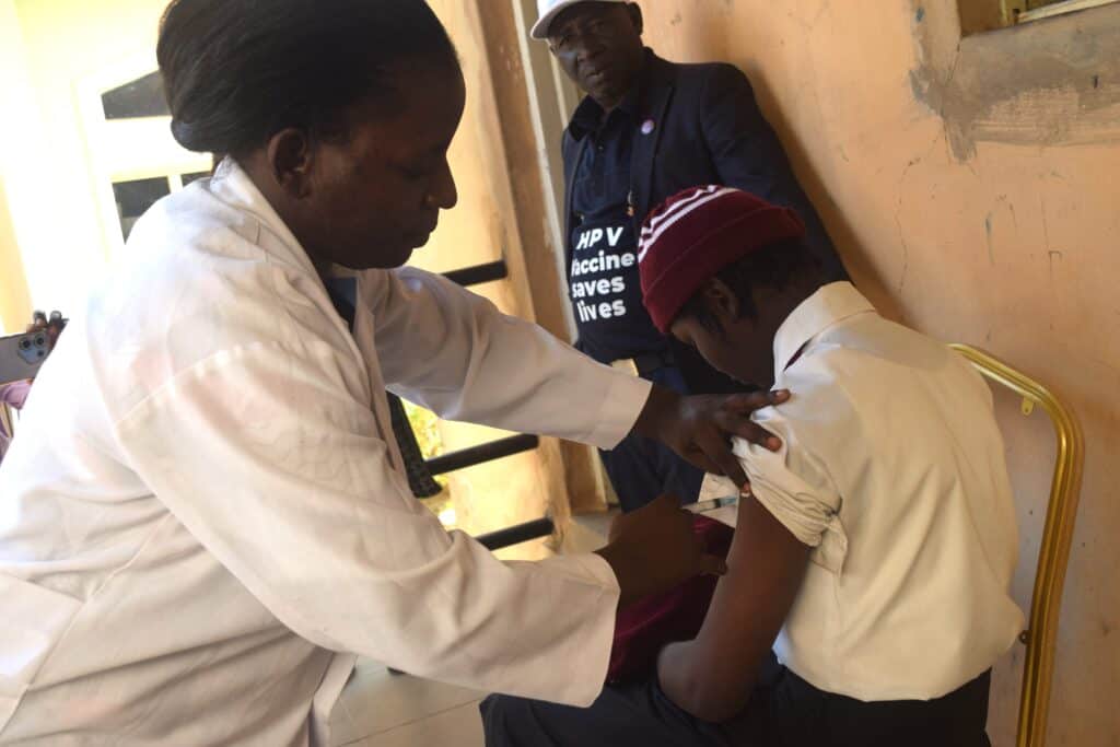 A nurse administers a vaccination.