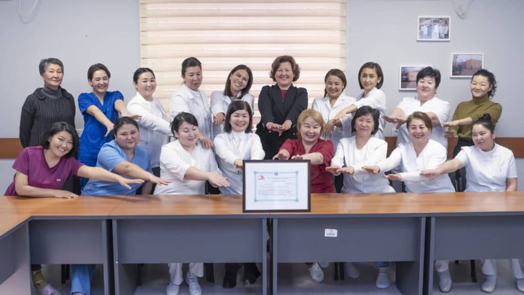 A group of employees at a lab pose for a photo