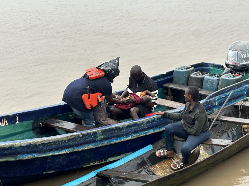 A father on a vaccination team vessel in Nigeria.