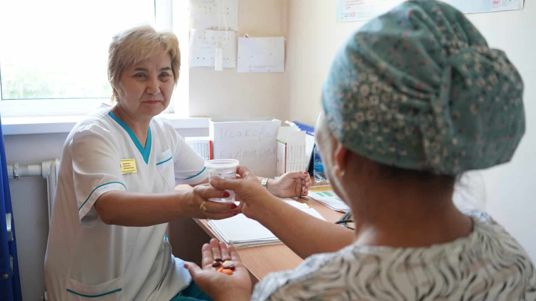 A family nurse at a Family Medicine Center in Bishkek, Kyrgyz Republic, gives a daily dose of TB drugs to a patient as part of directly observed treatment, a case management approach to ensure quality care and treatment adherence.