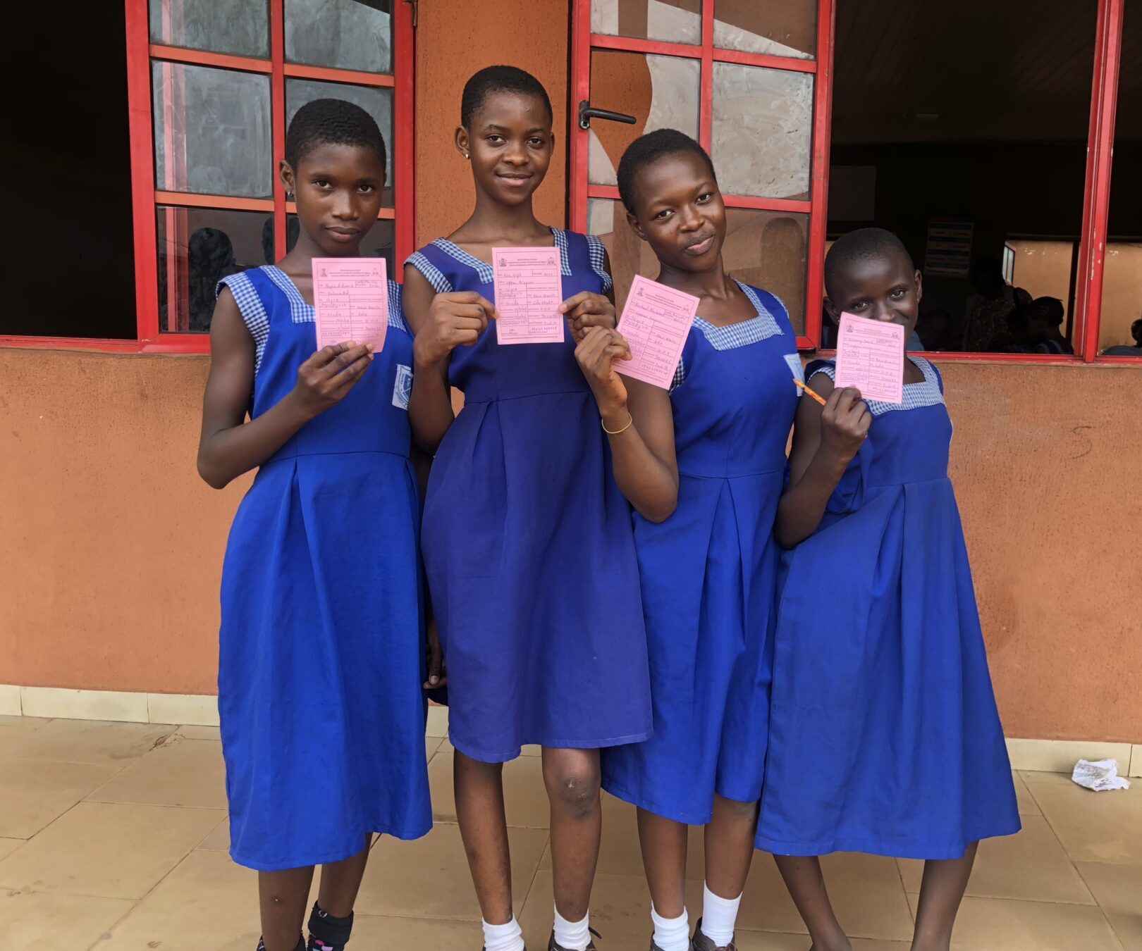 Edaiken Primary School students showing their vaccination cards.