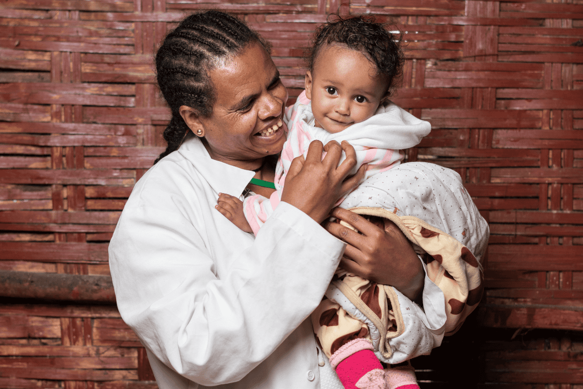 A midwife holds one of her patients after a check-up.