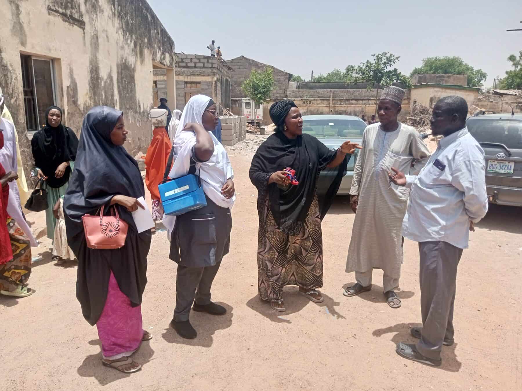 Saidu Kwamandi (second from right) joins an immunization team as they head to a local school to ensure every eligible girl receives the HPV vaccine.