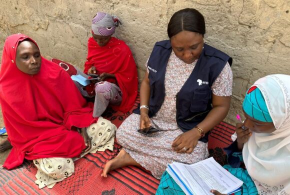 In Nigeria, a team member meets with household caregivers.